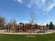 Community playground with colorful play equipment, swings, and a bench, perfect for Gathering enjoyment at 4711 S Logan St, Englewood, CO 80113