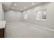 Spacious carpeted basement with recessed lighting and bright windows, perfect for recreation or storage at 2521 N Gaylord St, Denver, CO 80205