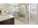 Modern bathroom with a glass-enclosed shower, soaker tub, and dual sink vanity at 2521 N Gaylord St, Denver, CO 80205