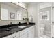 Modern bathroom featuring a vanity with a black marble countertop and black fixtures at 2521 N Gaylord St, Denver, CO 80205