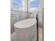 Sleek bathroom with a modern soaking tub, white tile flooring, and brass fixtures at 2521 N Gaylord St, Denver, CO 80205