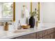 Stylish bathroom featuring double sinks with gold hardware, a dark wood vanity, and modern decor at 2521 N Gaylord St, Denver, CO 80205