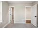 Carpeted bedroom with white trim featuring two white doors leading to other rooms at 2521 N Gaylord St, Denver, CO 80205
