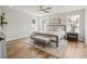 Spacious bedroom features a ceiling fan, bench, neutral decor, and hardwood flooring at 2521 N Gaylord St, Denver, CO 80205