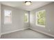 Bright bedroom with neutral walls, and three large windows providing plenty of natural light at 2521 N Gaylord St, Denver, CO 80205