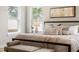 Comfortable main bedroom with a neutral color palette, bench, and natural light from the windows at 2521 N Gaylord St, Denver, CO 80205