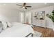 Bright bedroom featuring hardwood floors, a ceiling fan, and a modern dresser at 2521 N Gaylord St, Denver, CO 80205