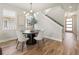Dining area featuring a modern chandelier, and view into the living room, staircase and front door at 2521 N Gaylord St, Denver, CO 80205