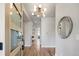 Bright foyer with modern lighting, hardwood floors, and a glimpse into the home's open layout at 2521 N Gaylord St, Denver, CO 80205