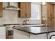 Modern kitchen with stainless steel appliances, a gas range, and stylish white and wood cabinetry at 2521 N Gaylord St, Denver, CO 80205