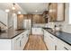 Spacious kitchen with stainless steel appliances, an island with bar seating, and modern fixtures at 2521 N Gaylord St, Denver, CO 80205