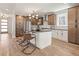 Modern kitchen featuring an island with barstool seating, stainless steel appliances, and mixed wood and white cabinetry at 2521 N Gaylord St, Denver, CO 80205