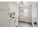 Bright laundry room featuring a sink, white cabinets, and modern lighting fixture at 2521 N Gaylord St, Denver, CO 80205