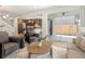 Open-concept living room with modern decor, sliding glass doors to the backyard, and seamless flow into the kitchen at 2521 N Gaylord St, Denver, CO 80205