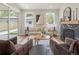Bright living room with a marble fireplace, neutral tones, and large windows that provide natural light at 2521 N Gaylord St, Denver, CO 80205
