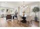 Bright living and dining area featuring modern lighting, neutral decor, and an open-concept design at 2521 N Gaylord St, Denver, CO 80205