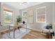 Bright home office with hardwood floors, a decorative rug, and lots of natural light from the large windows at 2521 N Gaylord St, Denver, CO 80205