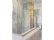 Close-up of the luxurious shower with blue marble and gold fixtures, for a modern look at 2521 N Gaylord St, Denver, CO 80205