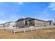 View of the backyard with a white fence, patio, and the home's exterior at 18001 Herrera Dr, Parker, CO 80134