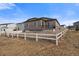 Backyard view featuring a white fence, patio and the home's exterior in a residential neighborhood at 18001 Herrera Dr, Parker, CO 80134