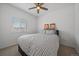 Bright bedroom features a ceiling fan, baseball wall art, and a comfortable bed with striped bedding at 18001 Herrera Dr, Parker, CO 80134