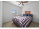 Bedroom features a ceiling fan, football wall art, and a comfortable bed with plaid bedding at 18001 Herrera Dr, Parker, CO 80134