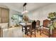 Bright dining room featuring hardwood floors, an elegant light fixture, and ornately carved table and chairs at 6034 S Niagara Ct, Centennial, CO 80111