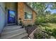 Front entrance featuring a brick exterior, and a well-manicured garden with mature trees at 6034 S Niagara Ct, Centennial, CO 80111