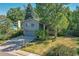 Front exterior showing a two-story house with mature trees, lawn, and a driveway at 6034 S Niagara Ct, Centennial, CO 80111
