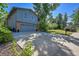 Two-story house featuring a gray exterior, two-car garage, concrete driveway and a well-manicured lawn at 6034 S Niagara Ct, Centennial, CO 80111