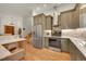 Modern kitchen with stainless steel appliances, custom cabinets, and marble countertops at 6034 S Niagara Ct, Centennial, CO 80111