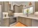 Well-lit kitchen featuring stainless steel appliances, countertops, and a stylish backsplash at 6034 S Niagara Ct, Centennial, CO 80111
