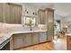 Kitchen with custom cabinets, marble countertops, and view of natural lighting through a large window at 6034 S Niagara Ct, Centennial, CO 80111