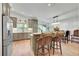 Kitchen with stainless steel appliances, island seating, and stylish backsplash at 6034 S Niagara Ct, Centennial, CO 80111