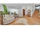 Bright living room with hardwood floors, white walls, and a large window with natural light at 6034 S Niagara Ct, Centennial, CO 80111