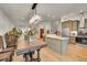 Open-concept living space showcasing modern kitchen with island and adjacent dining area with hardwood floors at 6034 S Niagara Ct, Centennial, CO 80111