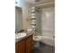 Clean bathroom featuring a vanity with granite countertop, toilet, and bathtub with shower, all in neutral tones at 10785 W 63Rd Pl # 105, Arvada, CO 80004