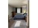 Bedroom with a calming color palette featuring wood furniture, carpeting, and natural light at 10785 W 63Rd Pl # 105, Arvada, CO 80004