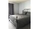 Comfortable bedroom showcasing a stylish iron bed frame and neutral color scheme at 10785 W 63Rd Pl # 105, Arvada, CO 80004