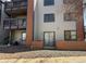 Exterior view of building with balconies, brick accents, and manicured landscaping at 10785 W 63Rd Pl # 105, Arvada, CO 80004