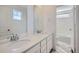 Bright bathroom features double sink vanity with white cabinets and modern fixtures at 5581 Inland Ave, Firestone, CO 80504