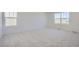 Light-filled bedroom with neutral carpeting and a view of the landscape at 5581 Inland Ave, Firestone, CO 80504