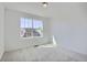 Bedroom with neutral carpeting and a window with a view of the neighborhood at 5581 Inland Ave, Firestone, CO 80504