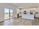 Kitchen and dining area with stainless steel appliances, island and a patio sliding glass door at 5581 Inland Ave, Firestone, CO 80504