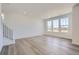 Bright living room with hardwood floors, fresh white walls, and large windows at 5581 Inland Ave, Firestone, CO 80504