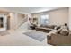 Finished basement with grey carpet, a large sectional sofa, and a drum set at 10723 Sedalia St, Commerce City, CO 80022