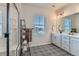 Bathroom featuring a glass enclosed shower with subway tile, black metal storage, and double vanity at 10723 Sedalia St, Commerce City, CO 80022