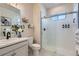 Bathroom featuring a glass enclosed shower, marble vanity and stylish decor at 10723 Sedalia St, Commerce City, CO 80022