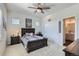 Bedroom with sporty decor, a ceiling fan, a large closet, and an attached bathroom at 10723 Sedalia St, Commerce City, CO 80022
