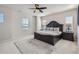 Spacious main bedroom with a decorative ceiling fan, large bed, and ample natural light at 10723 Sedalia St, Commerce City, CO 80022